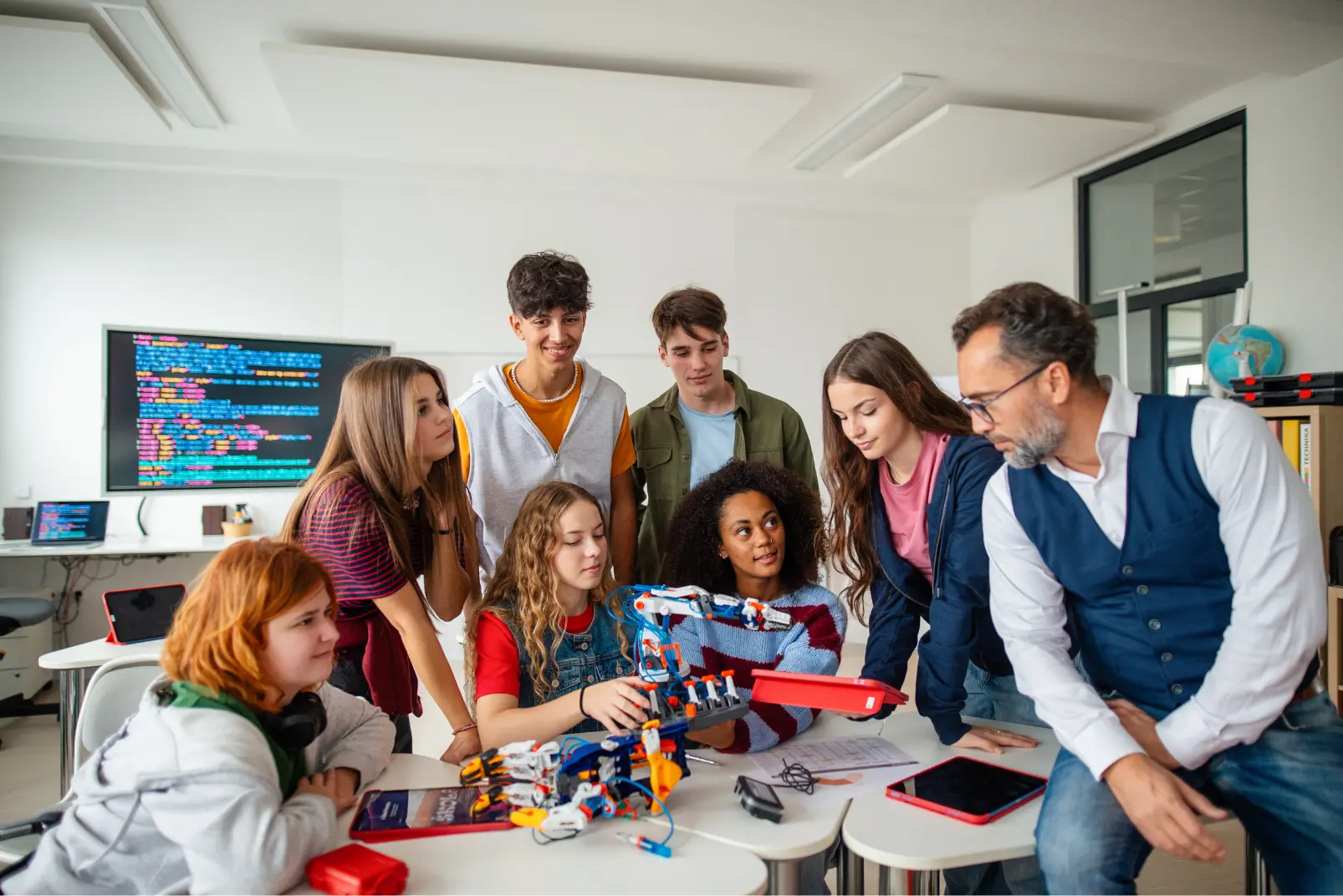 Teacher and students playing foosball together in a gamified classroom setting