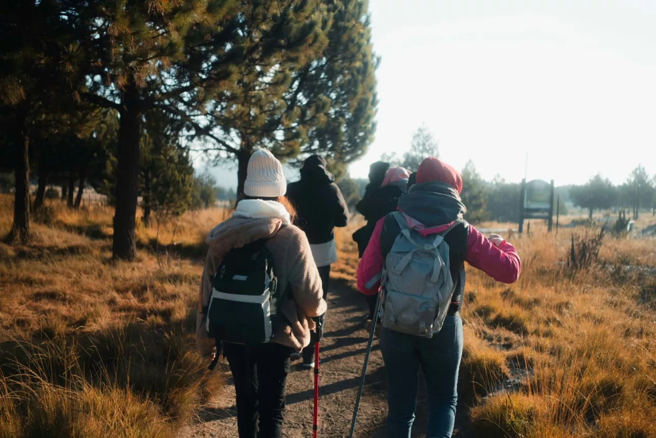 Student group hiking through nature during a GPS-based outdoor field study